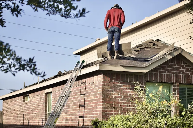 Professional roofer working on a residential roof in Pinckney Landing